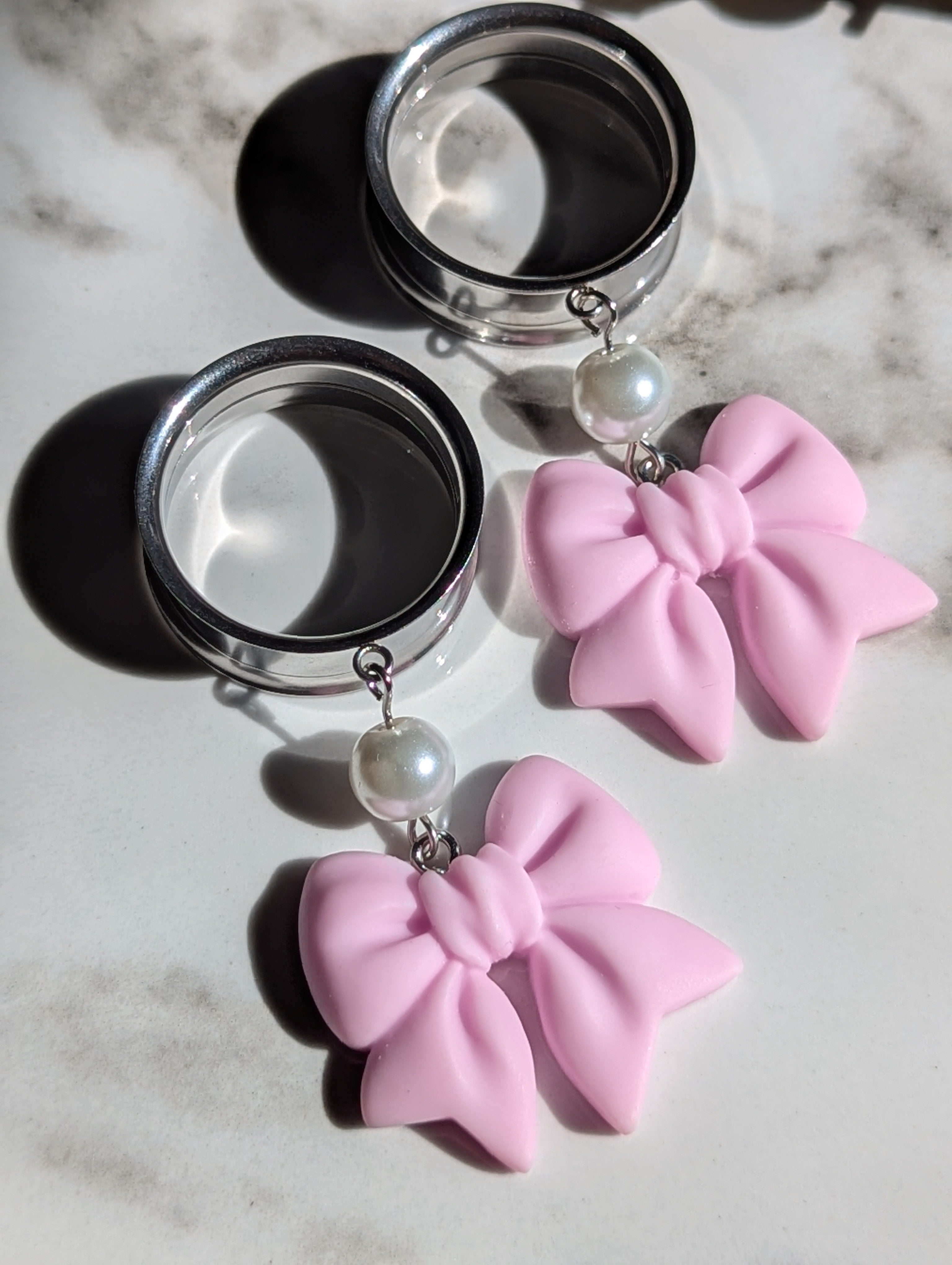 Pink bow dangle gauges