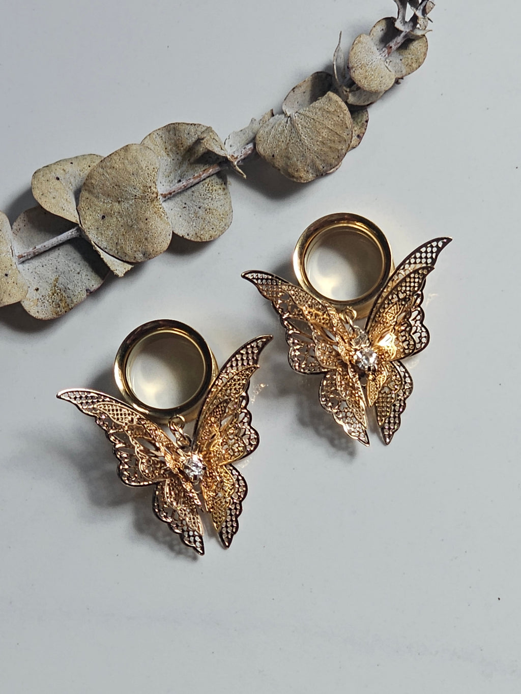 Fluttering butterfly dangle gauges