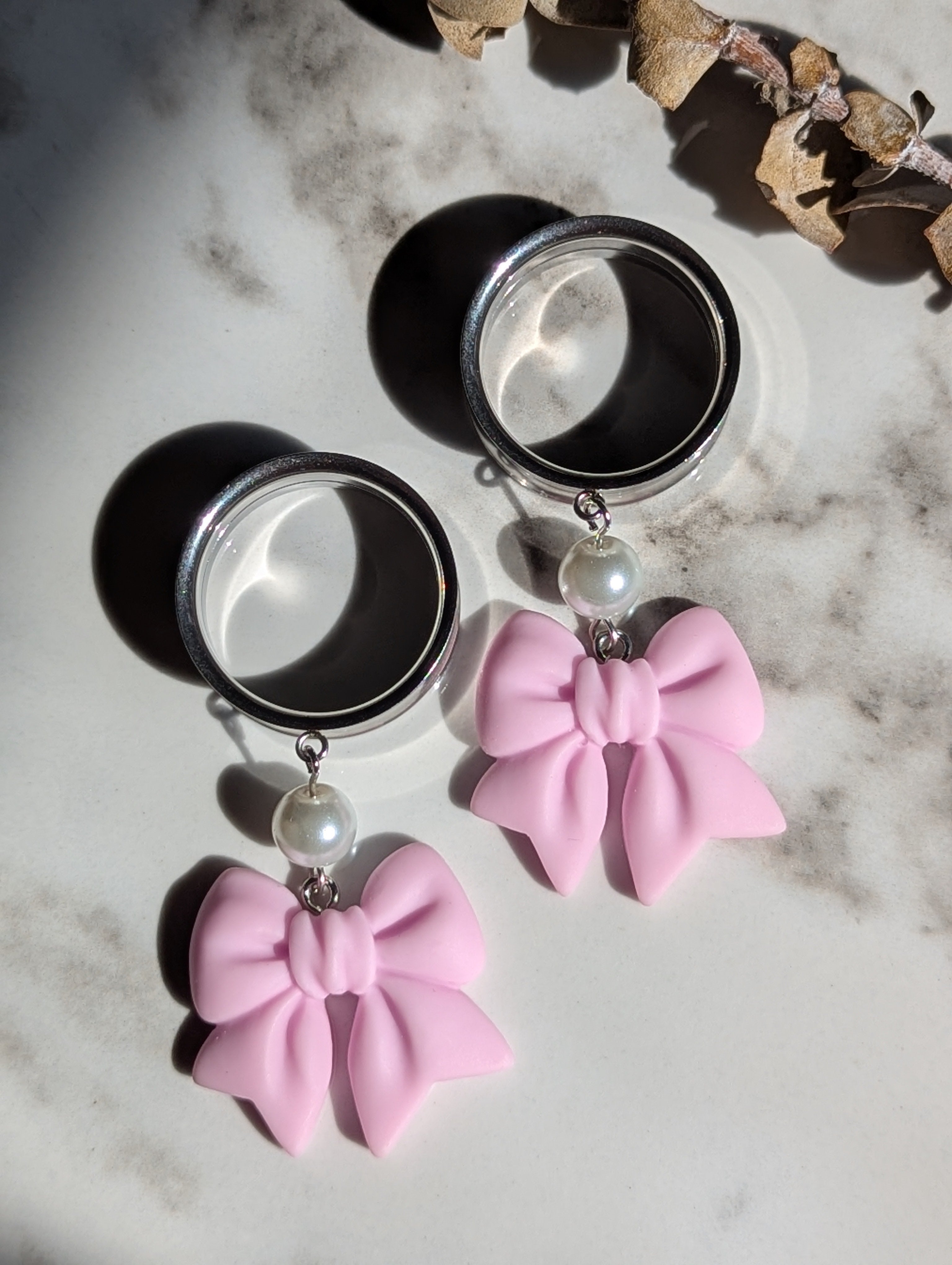 Pink bow dangle gauges