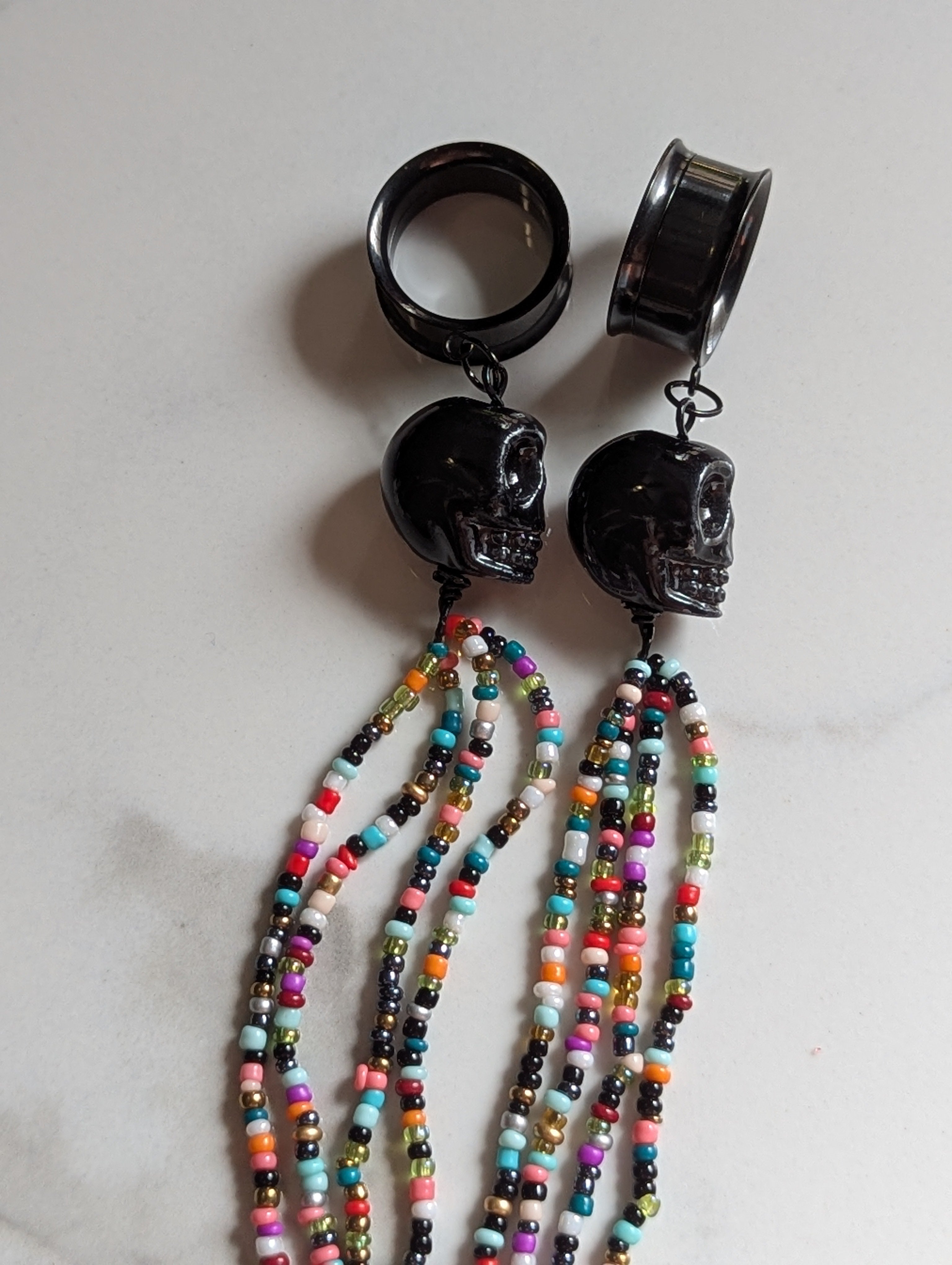 Beaded Skull tasseled dangle gauges